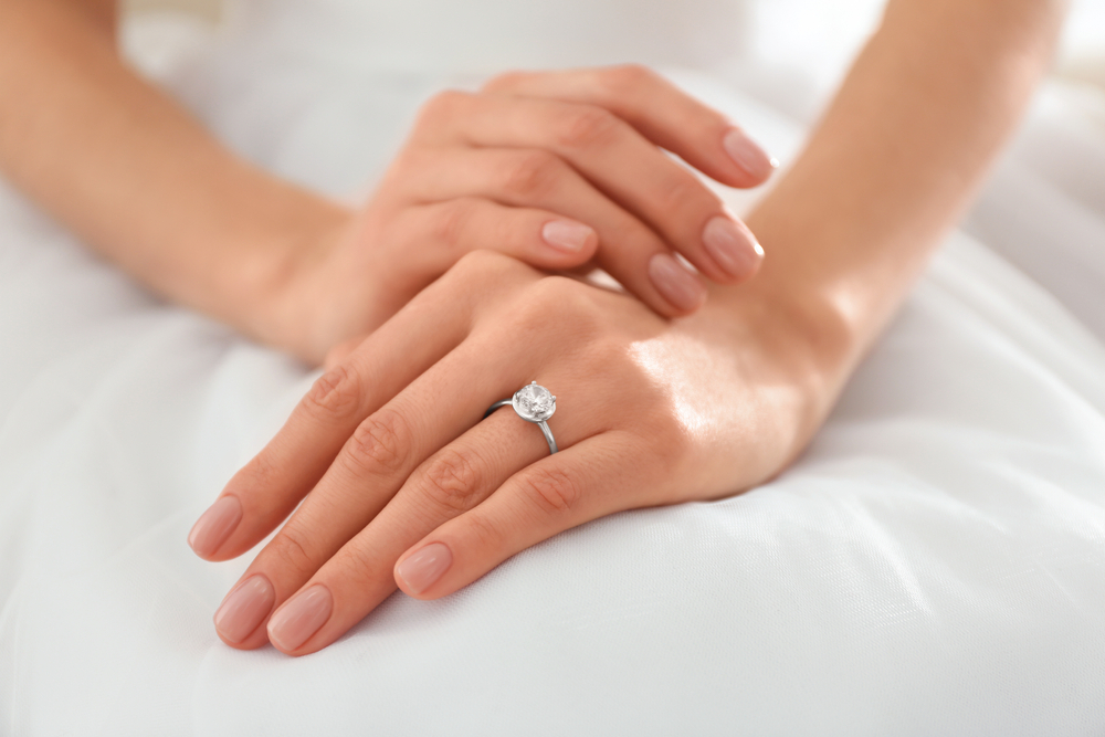 Woman wearing engagement ring on left finger